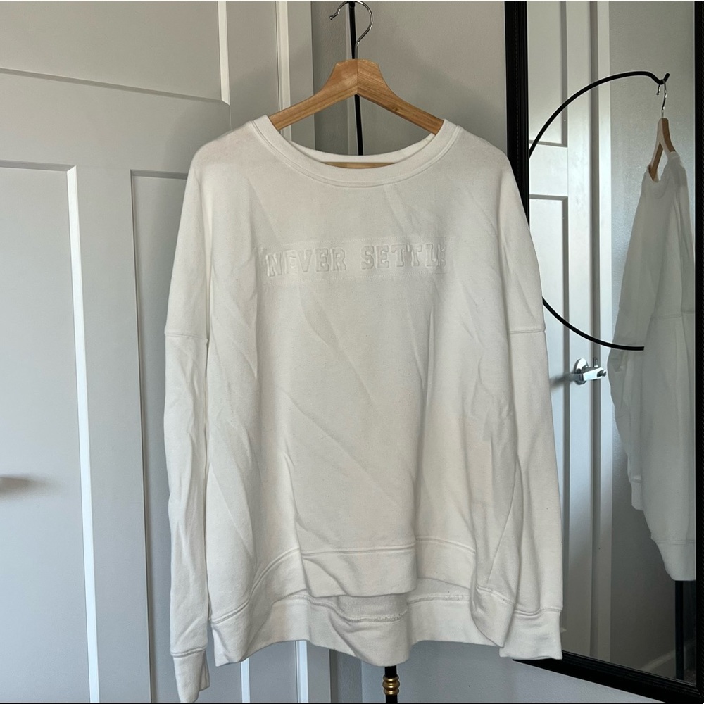 White Fabletics “Never Settle” Pullover Sweatshirt